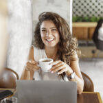 Young woman having coffee with someone at a coffee shop