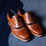 close up of a pair of men's, tan oxford shoes
